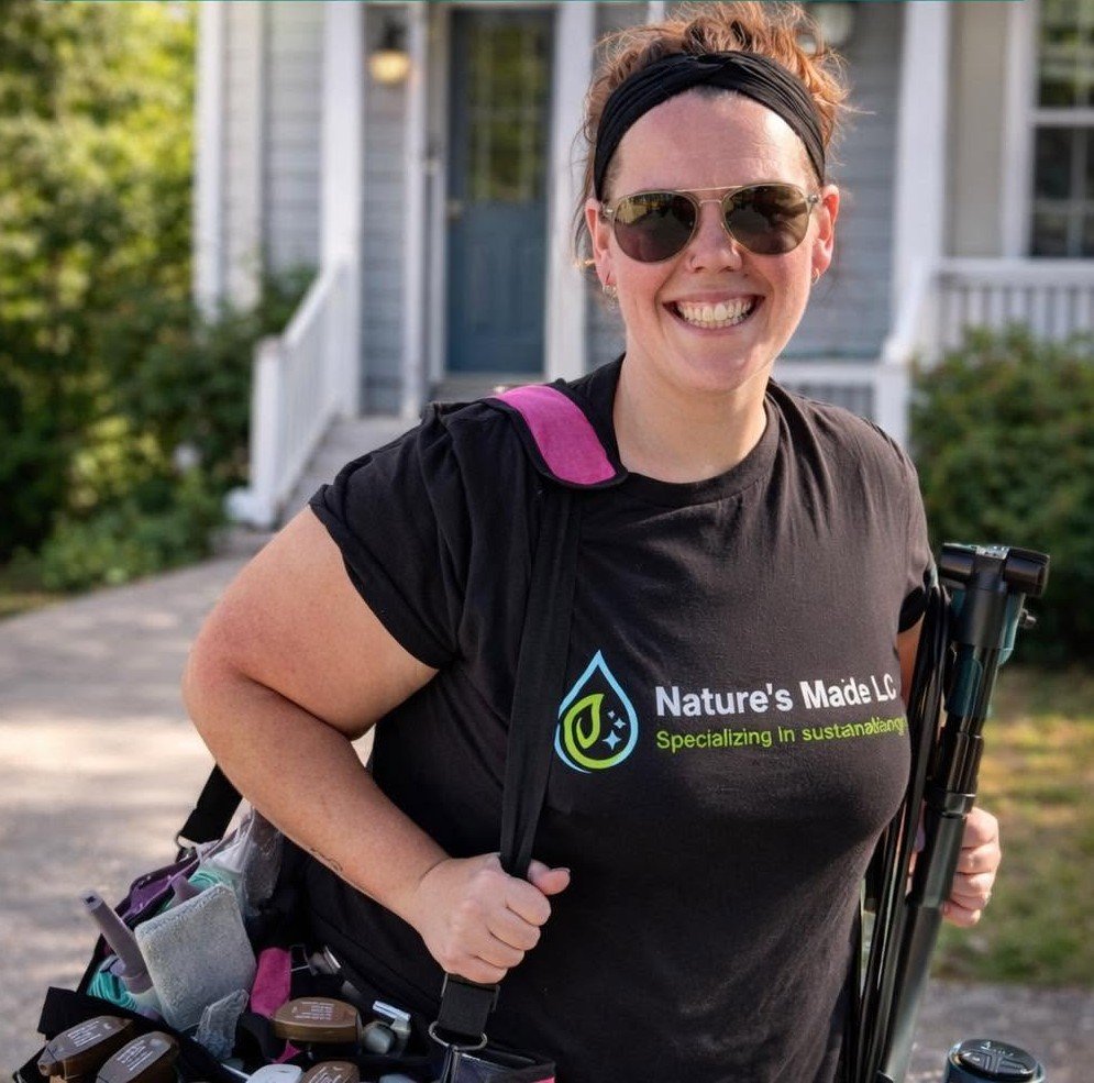Jessica, owner of Nature's Maid LLC, arriving at a client's home with her cleaning kit